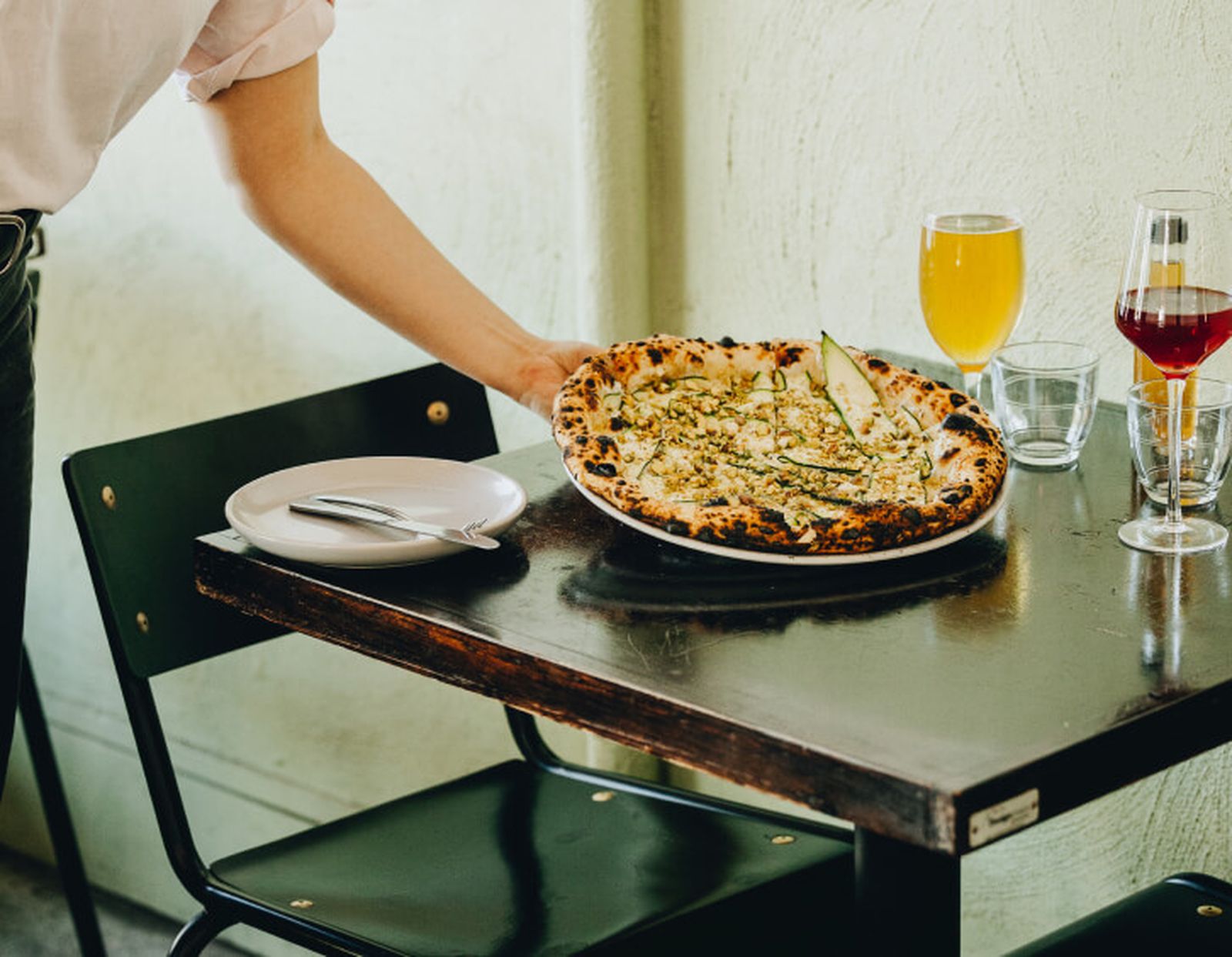 Pizza being served in restaurant